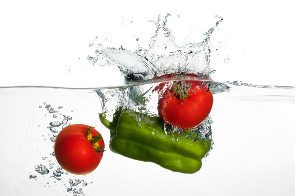 Fresh Tomatoes and Green Pepper Splash in Water Isolated on Whit - Photo, Image