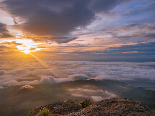 Beautiful Sunrise Sky with Sea of the mist of fog in the morning on Khao Luang mountain in Ramkhamhaeng National Park,Sukhothai province Thailand - Photo, Image