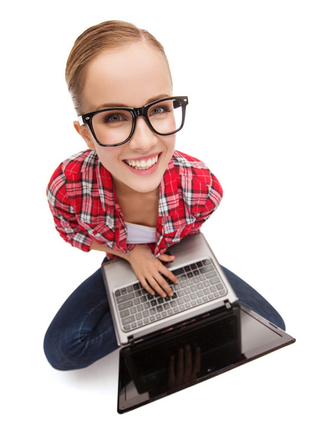 Smiling teenage girl in eyeglasses with laptop - Valokuva, kuva