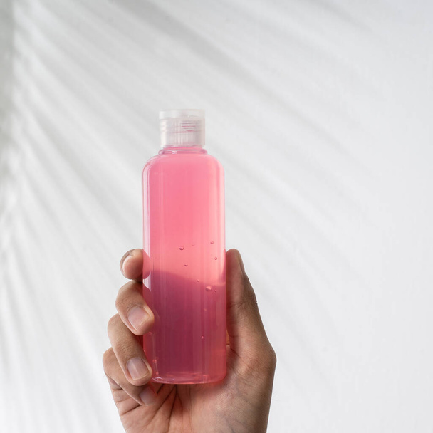 hand holding plastic bottle hand sanitizer mockup - Фото, зображення