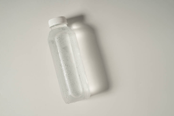liquid product on blank plastic container bottle - Fotoğraf, Görsel