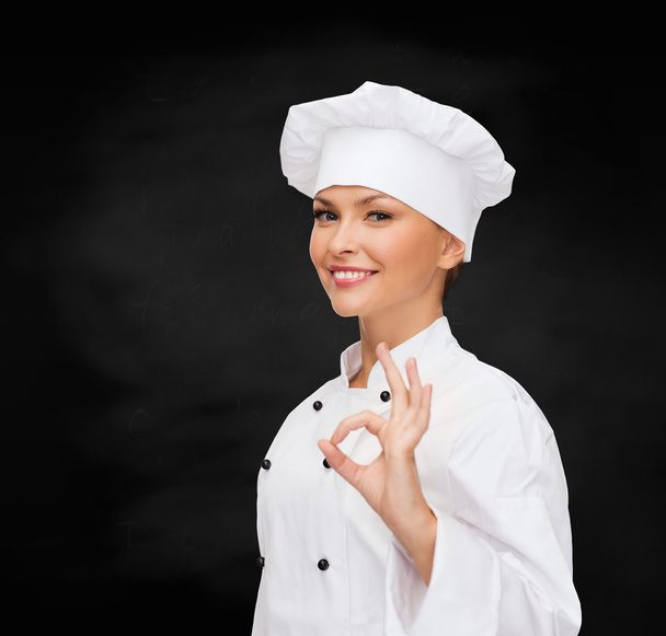 Smiling female chef showing ok hand sign - Fotografie, Obrázek