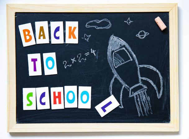 Back to school concept with hand drawn rocket and text on blackboard. - Fotó, kép