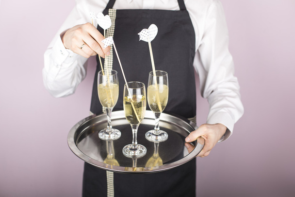 Waiter carrying a tray with champagne - Foto, Imagen