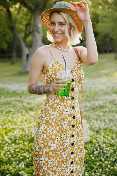 young hipster woman in summer dress and hat with summer accessories and cocktail. - Foto, imagen