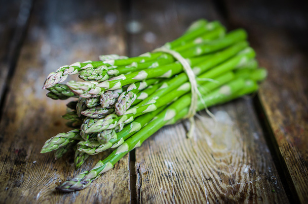 Asparagus on rustic wooden background - 写真・画像