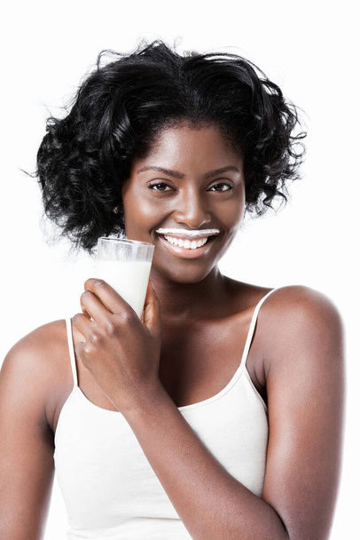 Attractive black woman drinking milk with milk moustache - Фото, зображення