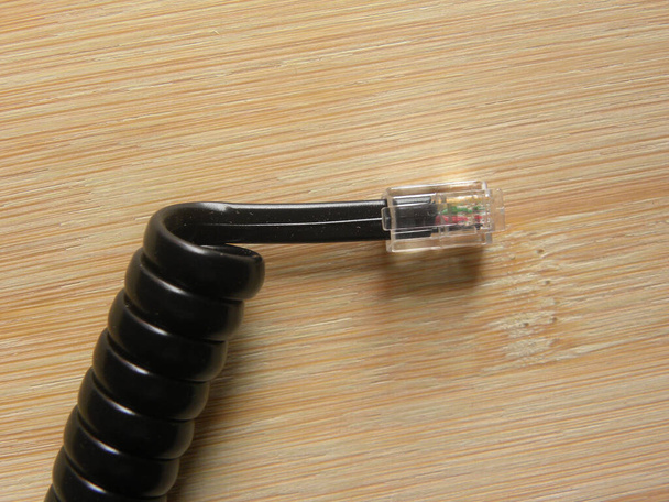 Black color spiral landline telephone handset connector cable jack - Photo, Image