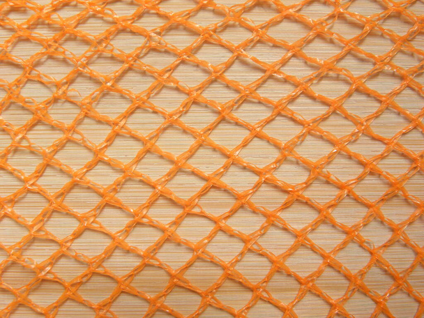 Orange color net bag textured background - Photo, Image