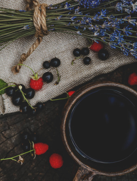 composition of lavender bouquet, berries and tea - Photo, image