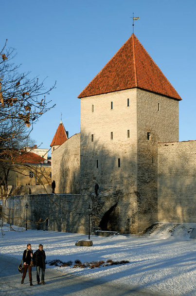 Tallinn, the capital city of Estonia. The Maiden Tower or Neitsitorn is a tower that forms part of the fortifications of Tallinn in Estonia. The city wall of Tallinn old town with people walking. - Zdjęcie, obraz