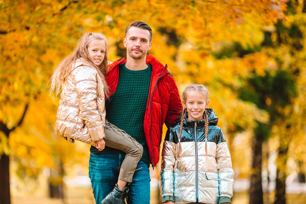 Family of dad and kids on beautiful autumn day in the park - Photo, Image