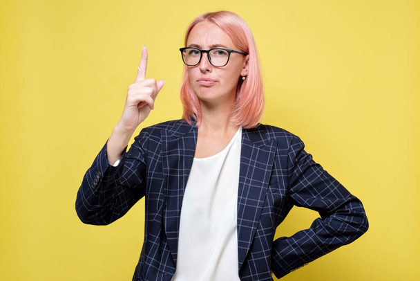 Strict young business woman pointing with finger up giving advice - Фото, изображение