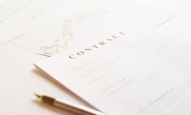 Contract paper and pen on white desk background. Focus on title Contract. Defocused pencil. - Fotó, kép