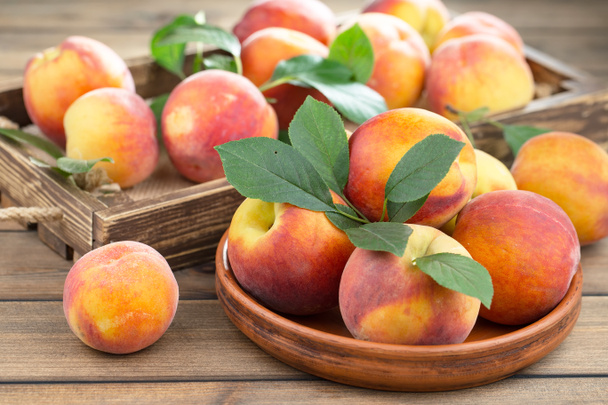 Ripe peaches on an old background - Photo, Image