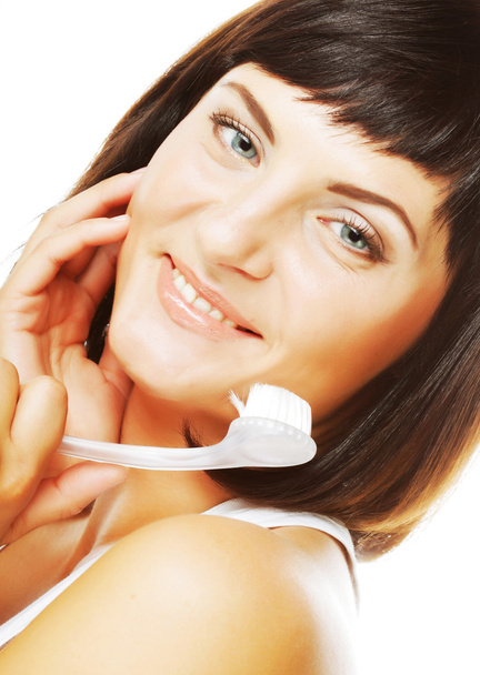 Girl cleaning face with peeling brush - Foto, Bild