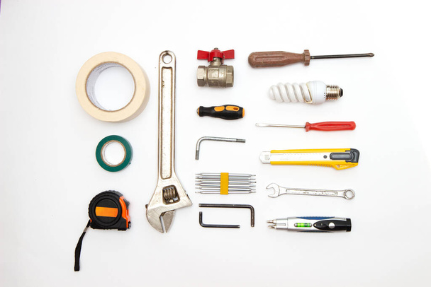 decorating and house renovation tools and other essentials on white background top view. flat lay composition - Valokuva, kuva