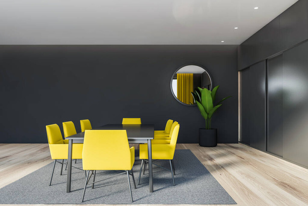 Interior of stylish dining room with gray walls, wooden floor, long dining table with yellow chairs and round mirror. 3d rendering - Photo, Image