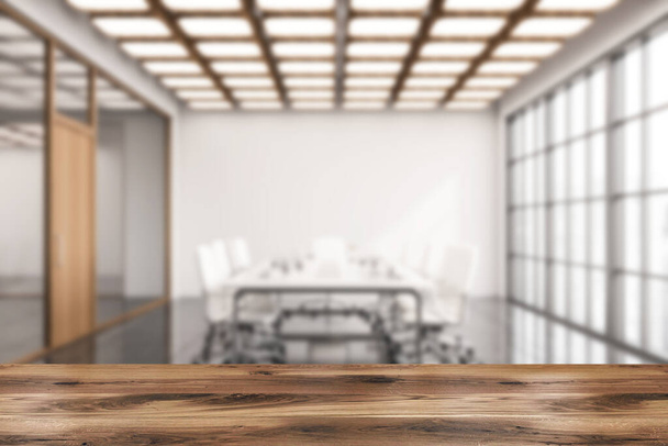 Wooden table for your product in blurry meeting room with white walls, tiled floor, long conference table with white chairs. 3d rendering mock up - Foto, Bild