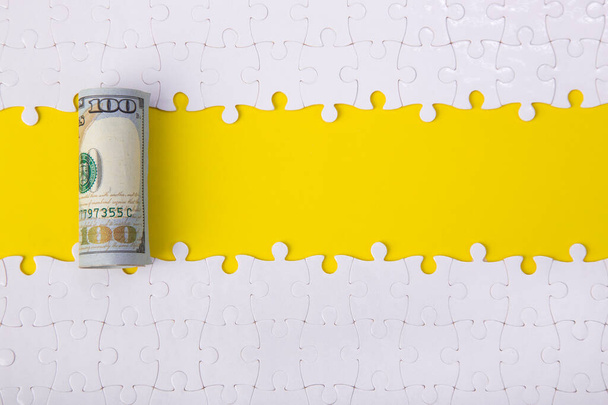 100 dollar on jigsaw puzzle pieces background, Business solution concept, Key for success concept. - 写真・画像