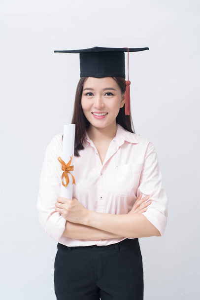 A portrait of beautiful young asian woman with education cap over white background Studio, Education concept .  - Foto, Imagem