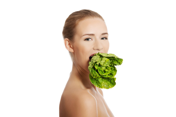 Woman with fresh green lettuce - Photo, image