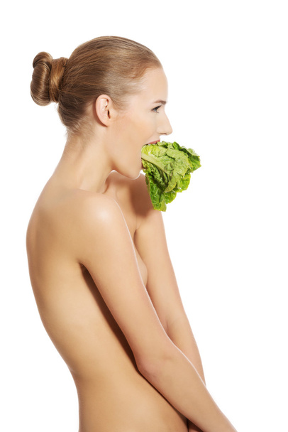 Woman with fresh green lettuce - Photo, image