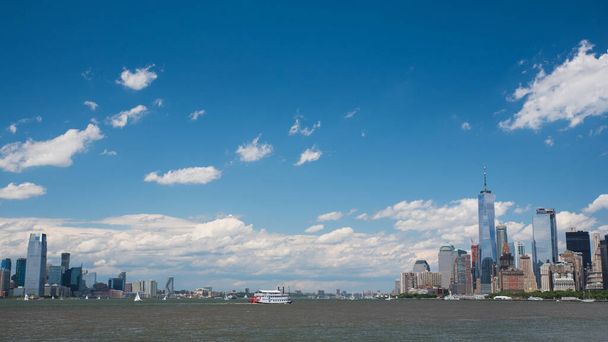A beautiful shot of the New York City skyline visible from the water - Фото, изображение