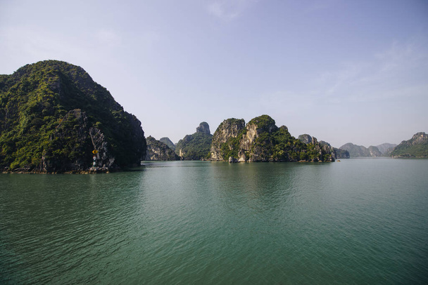 The tranquil waters of Ha Long Bay in Vietnam - Fotoğraf, Görsel