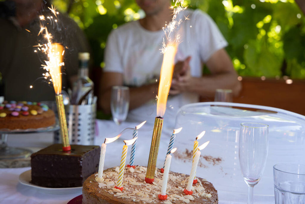 A closeup shot of firework candles on birthday cakes - Foto, Imagem