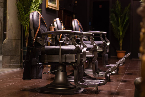 A beauty salon with leather chairs and luxury decorations - Фото, изображение