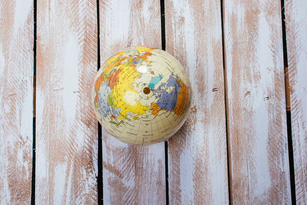 A top view of small globe on wooden surface - Fotoğraf, Görsel