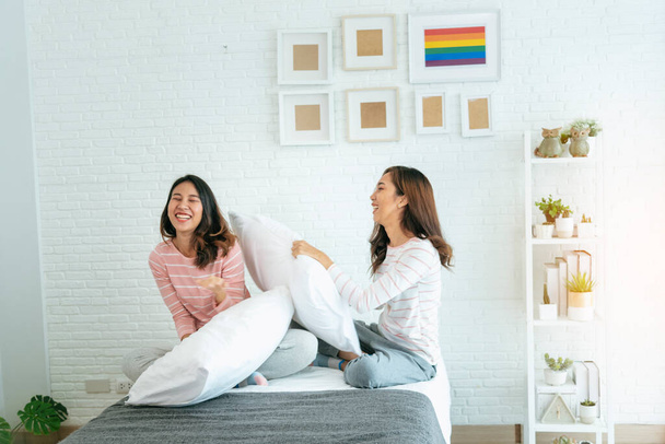 Two pretty best friends forever girlfriend talk, hug and laugh together on bed at cozy home relation fall in love. Lesbian couple homosexual happy lifestyle on bed. LGBTQ relation lifestyle concept. - Photo, Image