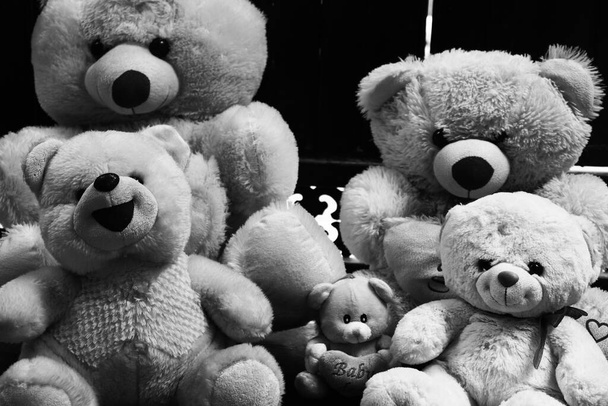 Toys plays teddy bear dark background - Photo, Image
