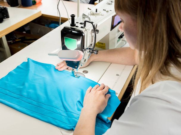 Designer tailor sew the dress. Woman use sewing machine for his work. - Photo, image