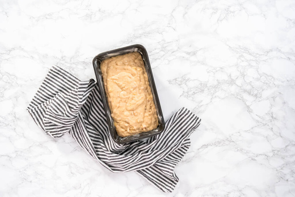 Flat lay. Banana nut bread batter in the loaf pan before baking. - Foto, afbeelding