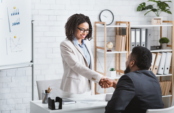 Black hiring manager shaking hands with successful vacancy candidate after work interview at office, copy space - Fotó, kép