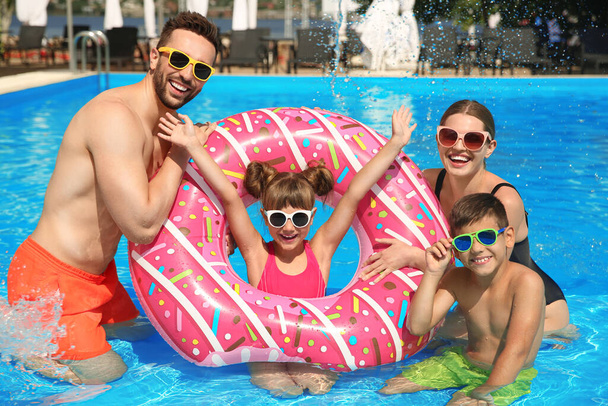 Happy family having fun in swimming pool - Photo, Image