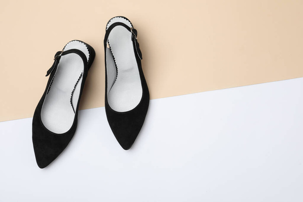 Stylish black female shoes on color background, flat lay. Space for text - Фото, изображение