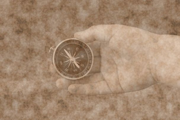 Abstraktes Bild mit Kompass in der Hand auf abstraktem Hintergrund als Symbol des Tourismus mit Kompass, Reisen mit Kompass und Outdoor-Aktivitäten mit Kompass - Foto, Bild