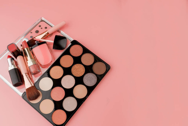 Various makeup productson pink background with copyspace. - Fotografie, Obrázek