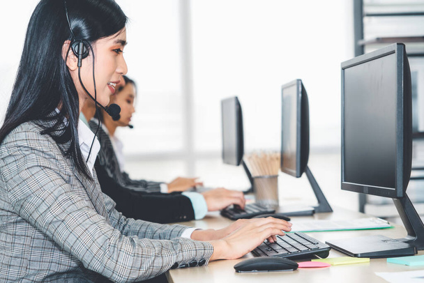 Business people wearing headset working in office to support remote customer or colleague. Call center, telemarketing, customer support agent provide service on telephone video conference call. - Zdjęcie, obraz