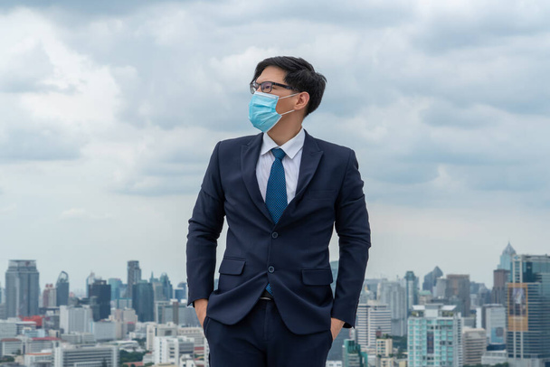 Young office worker with face mask quarantine from coronavirus or COVID-19. Concept of protective working environment to reopen business and stop spreading of coronavirus or COVID-19. - Photo, Image