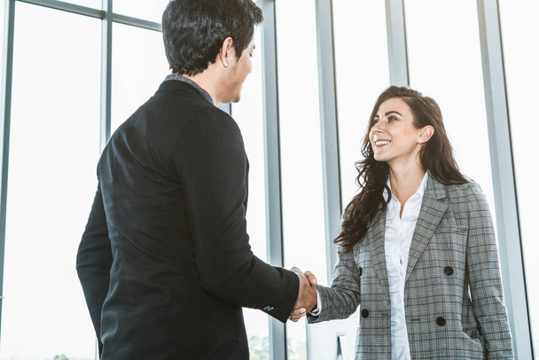 Business people handshake in corporate office showing professional agreement on a financial deal contract. - Foto, Imagen