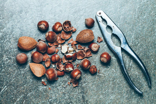 Hazelnuts, almonds and old nutcracker - Zdjęcie, obraz