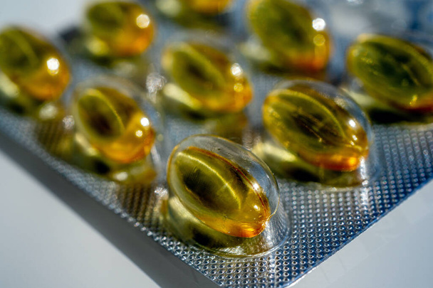 Close-up of gelatinous capsules with the cod-liver oil-omega3 in blister. - Photo, Image