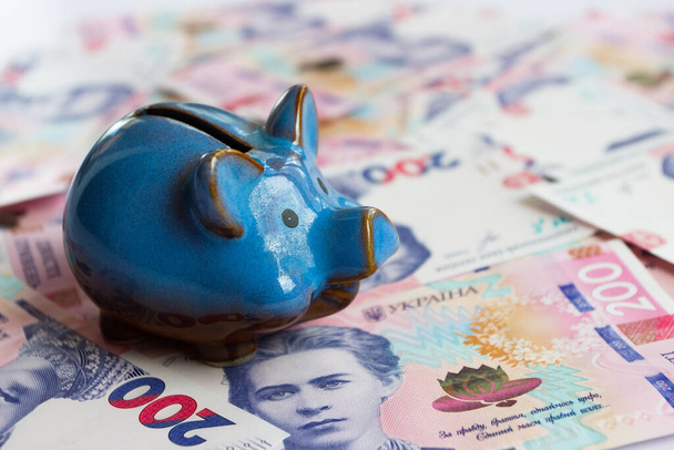Background from two hundred hryvnias with a piggy bank, business concept - Foto, Bild