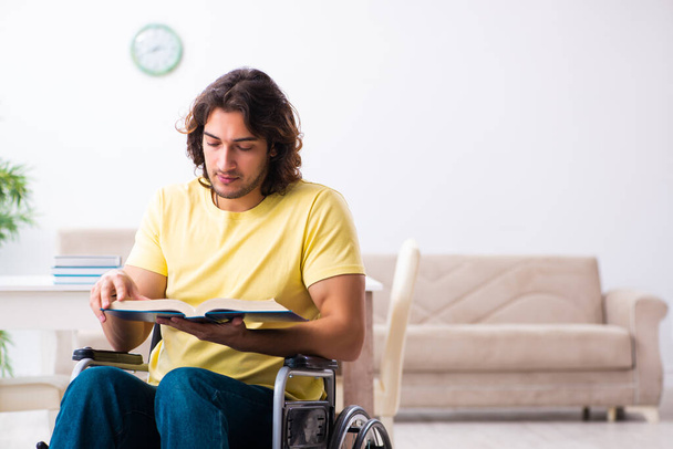 Male disabled student preparing for exams at home - Foto, imagen