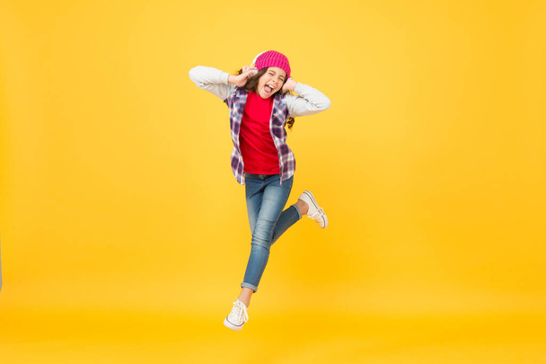 Happiness is the secret to all beauty. Happy girl enjoy music yellow background. Energetic child jump of happiness. Happiness concept. There is power in positivity - Fotó, kép