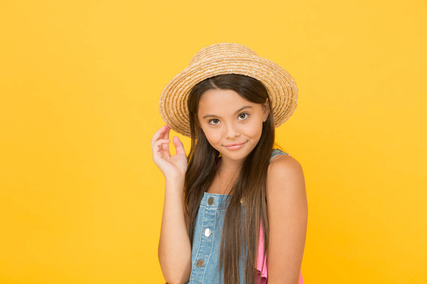 Enjoying vacation. Good vibes. Beach style. Little beauty in straw hat. Fancy outfit. Teen girl summer fashion. Summer holidays. Portrait of happy cheerful girl in summer hat yellow background - Photo, Image